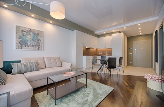 pexels-photo-1643383-1643383 Spacious modern living room featuring chic furniture, stylish decor, and a minimalist kitchen.